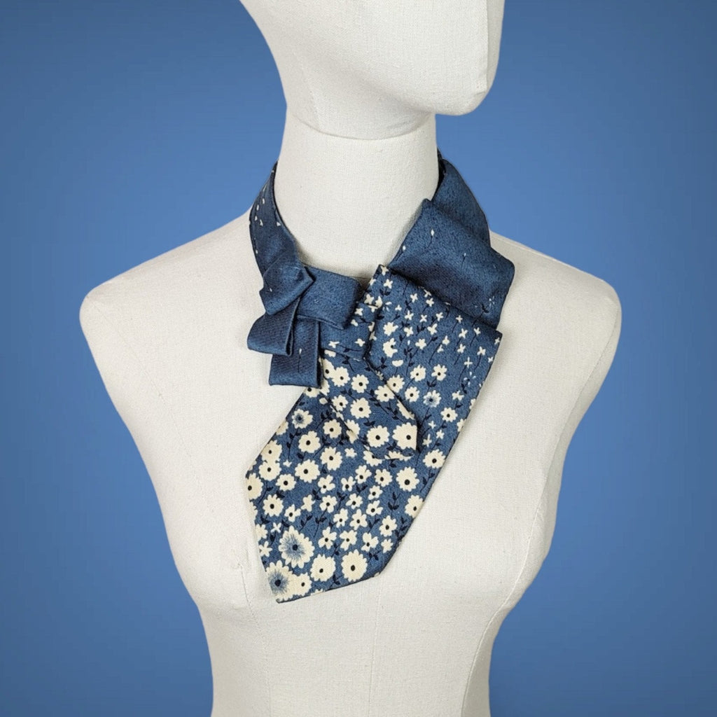 sapphire blue pleated ascot with small cream flowers on the lower half of the ascot