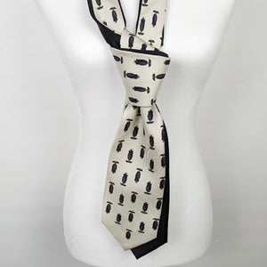 Double Necktie In black And Cream With A Print Of A Man