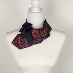 Load image into Gallery viewer, Ascot Scarf In Black With A Red And Grey Swirl Abstract Print.
