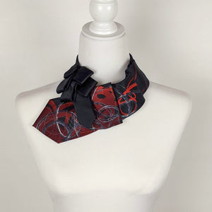 Ascot Scarf In Black With A Red And Grey Swirl Abstract Print.