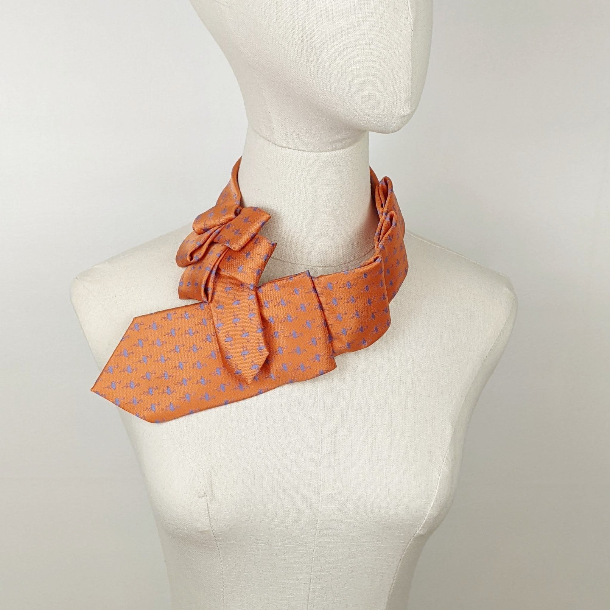 Scarf In Orange With A Blue Flamingo Print.