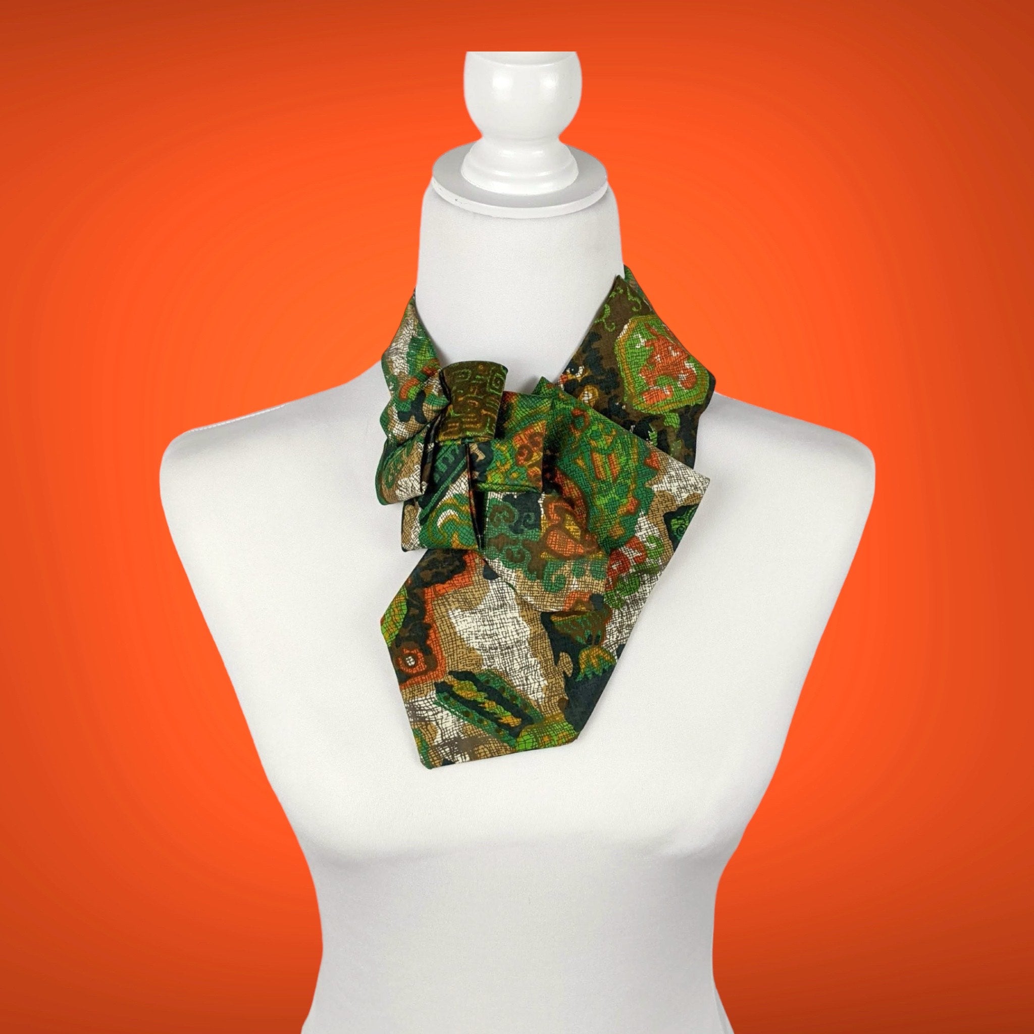 Ascot Scarf In A Green, Orange And Brown Print.