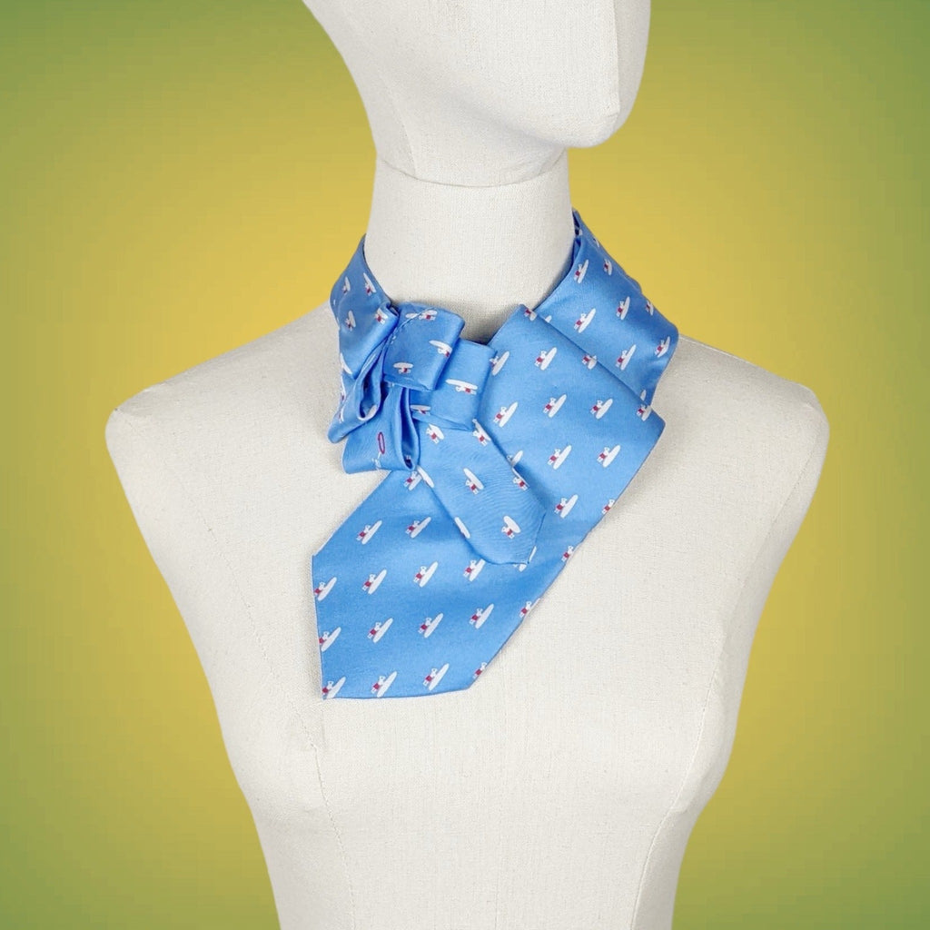 blue ascot scarf with a small print of a figure with a surf board