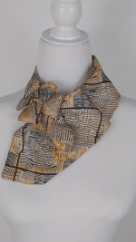 Load and play video in Gallery viewer, Ascot Scarf In Retro 60&#39;s Black And Gold Print.
