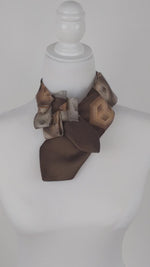 Load and play video in Gallery viewer, Women&#39;s Ascot Scarf In Retro Brown And Copper Geometric  Print.
