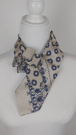Load and play video in Gallery viewer, Ascot Scarf In Sand and Navy Flowers and Pixies Print
