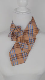 Load and play video in Gallery viewer, Ascot Scarf In Orange Plaid Print.
