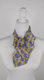 Load and play video in Gallery viewer, Ascot Scarf In Retro 60&#39;s Pink And Gold Print.
