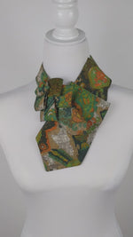 Load and play video in Gallery viewer, Ascot Scarf In A Green, Orange And Brown Print.
